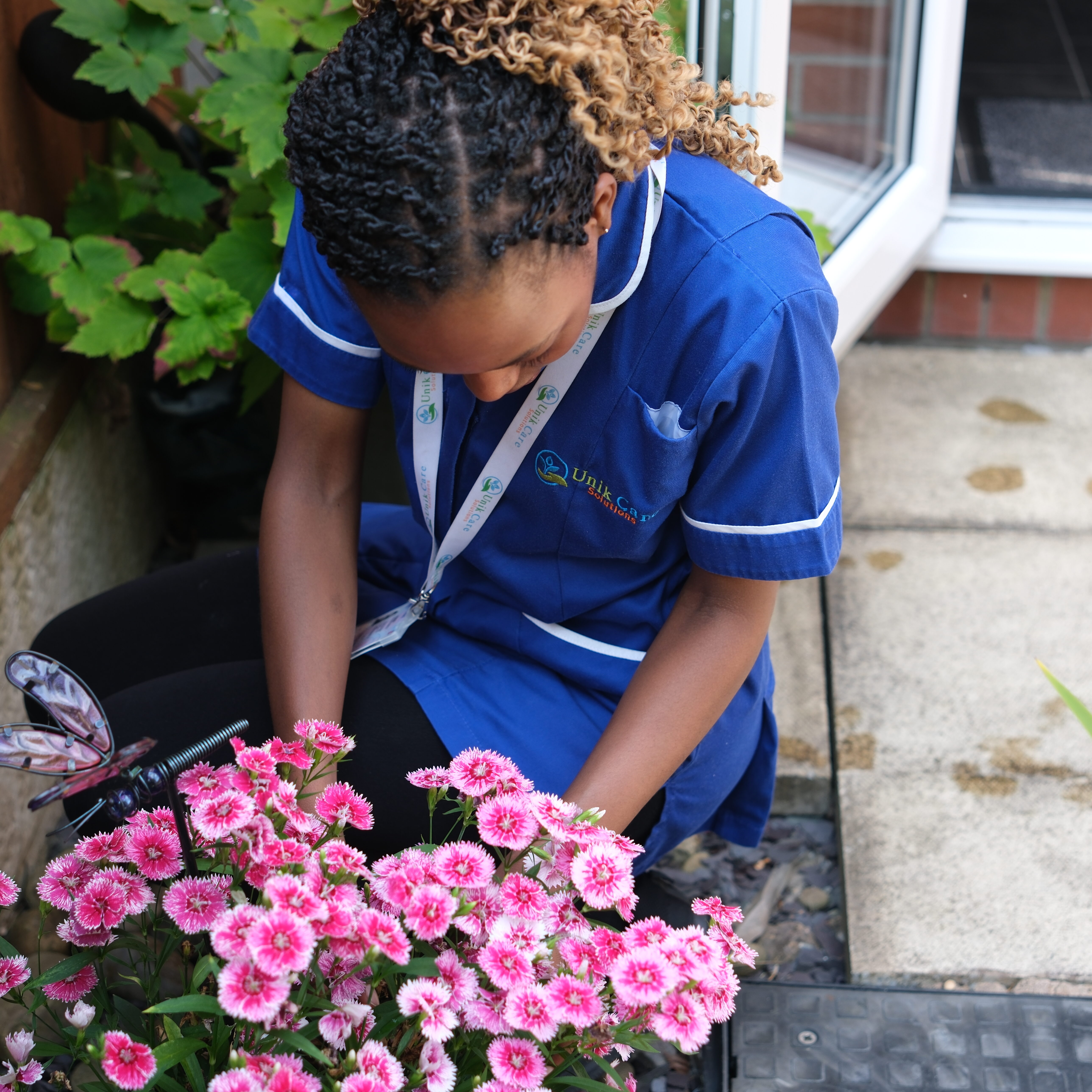 Nurse holding hand of senior woman in pension home